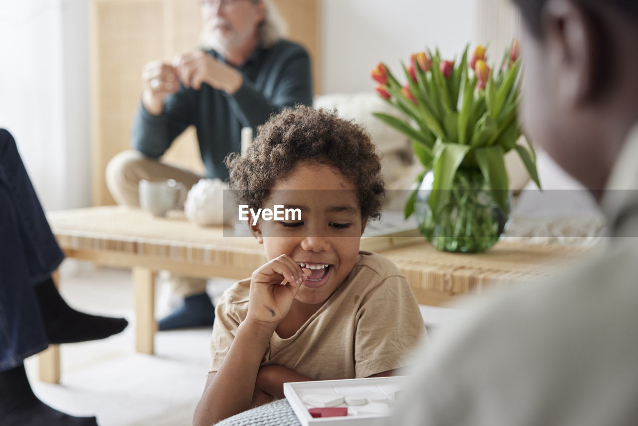 Family relaxing and playing games at home