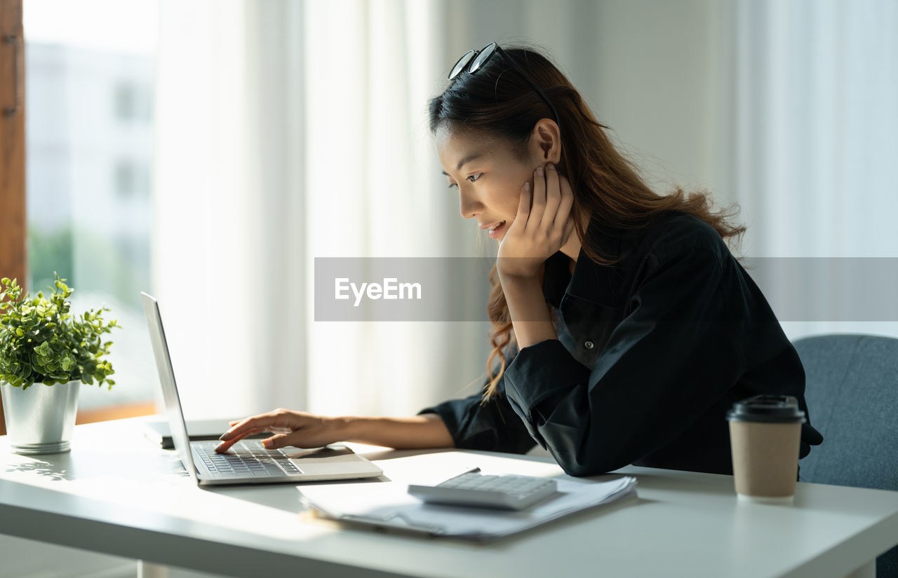 Businesswoman working at table