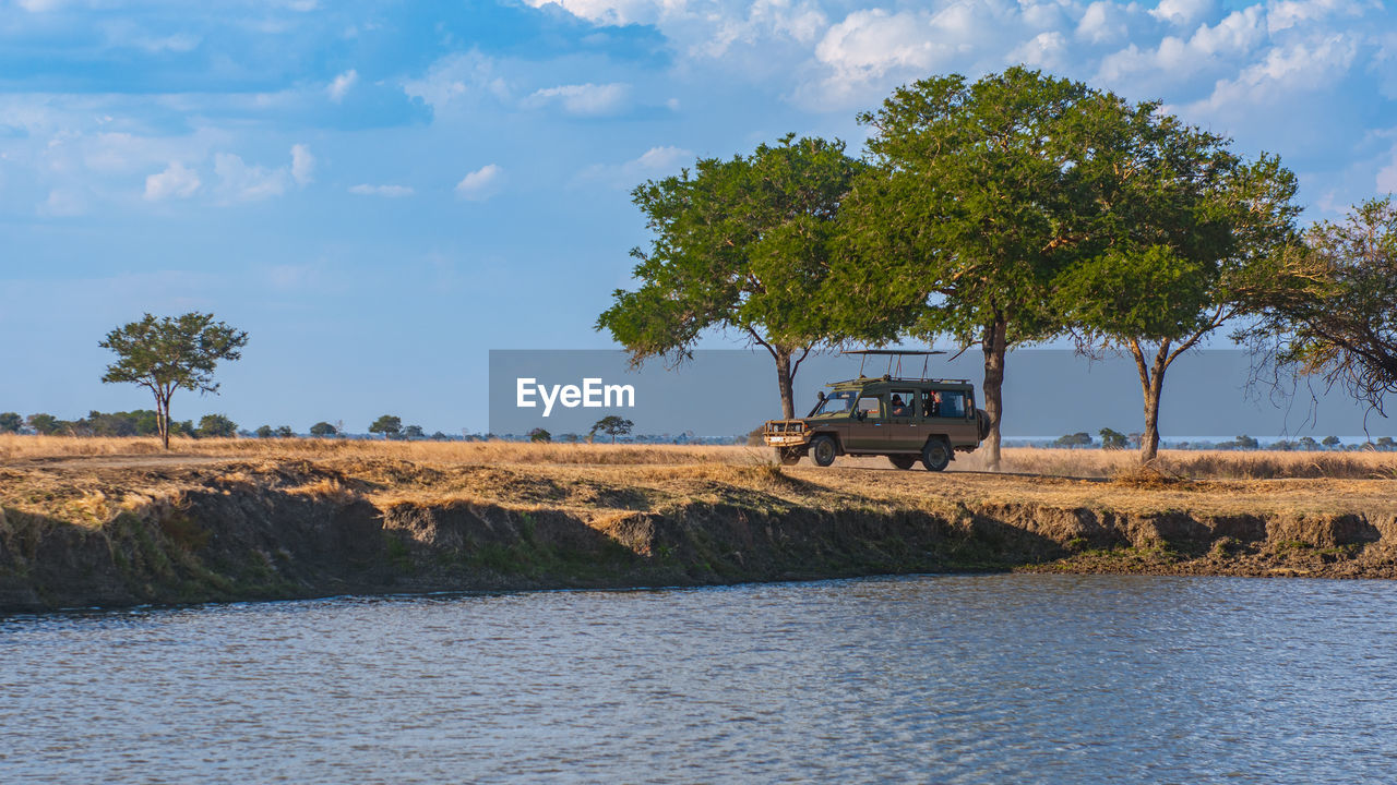 Scenic view of a safari motor vehicle in the wilderness 