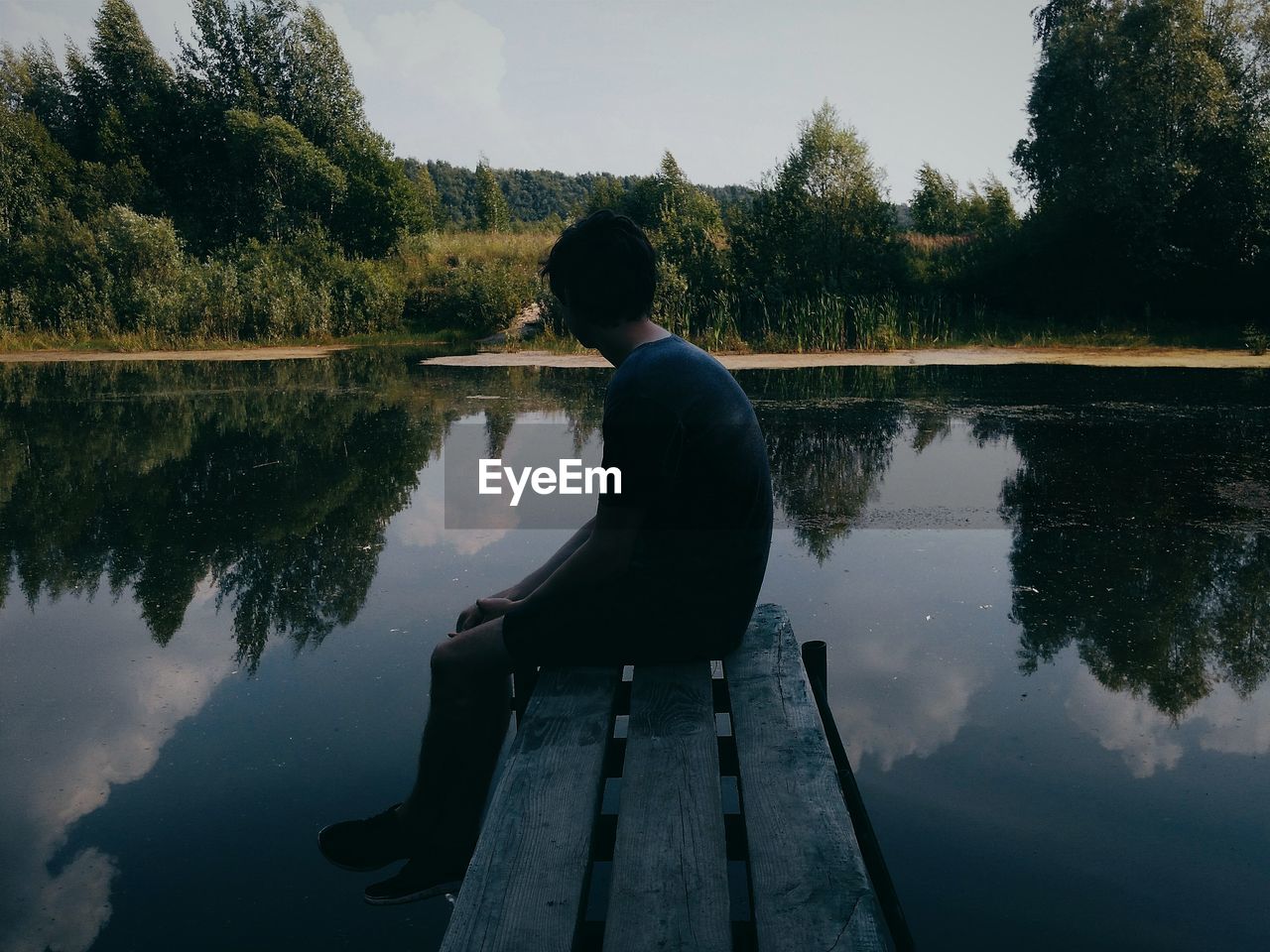 REFLECTION OF MAN IN SWIMMING POOL