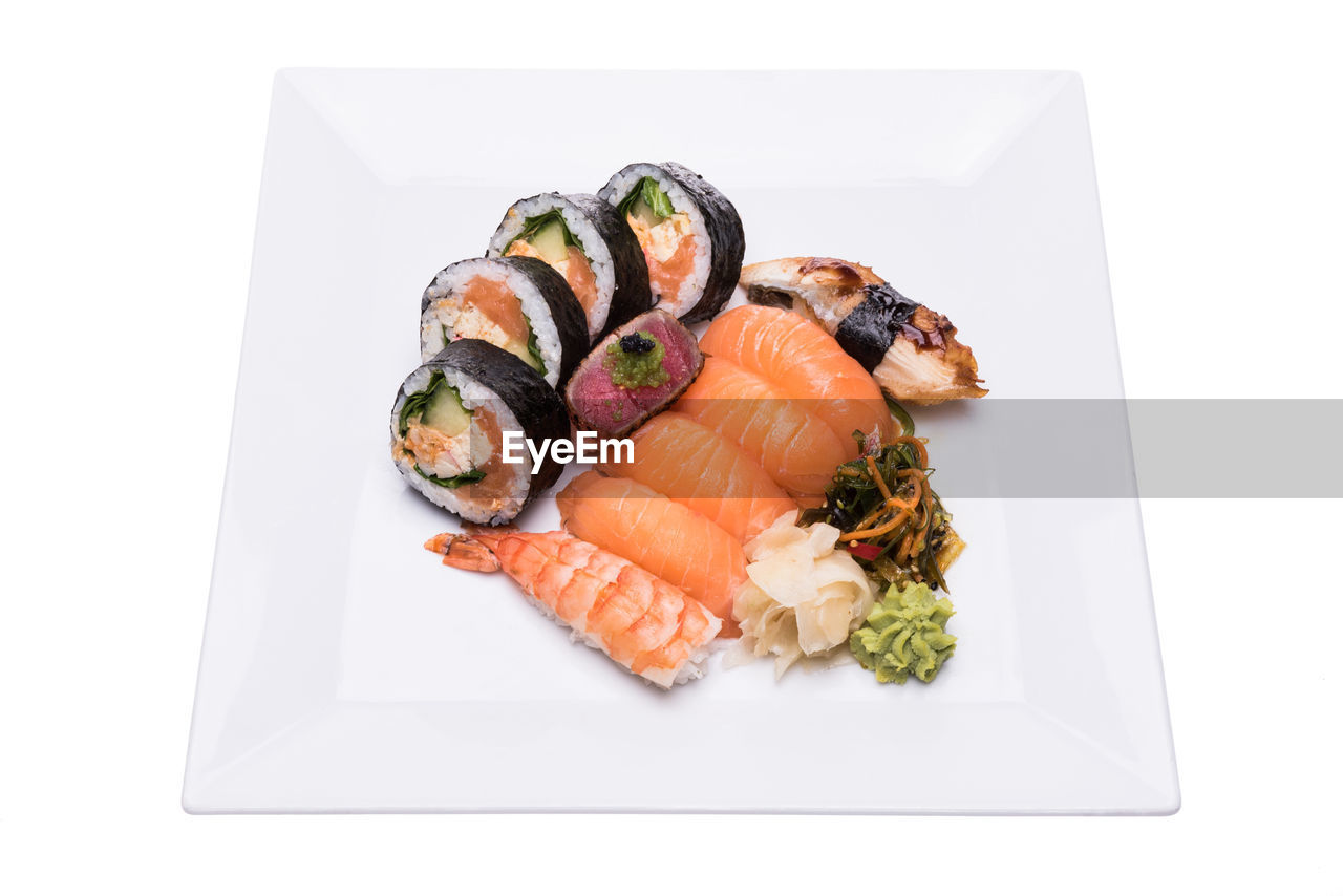 High angle view of fresh seafood on plate against white background