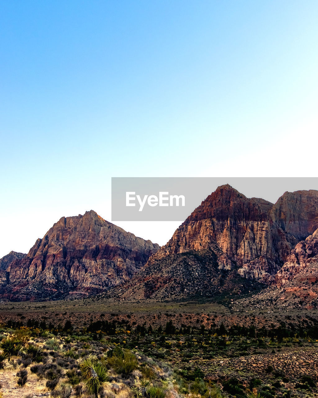 Scenic view of rocky mountains against clear blue sky