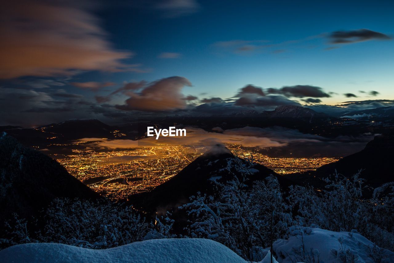 Aerial view of snowcapped mountains against sky during winter
