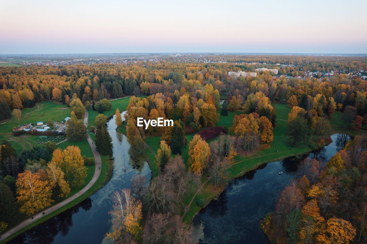 High angle view of river amidst trees against sky in the park