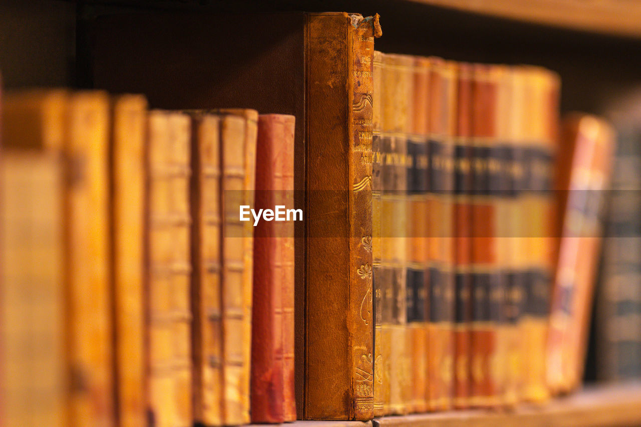 Close up of old books on shelf