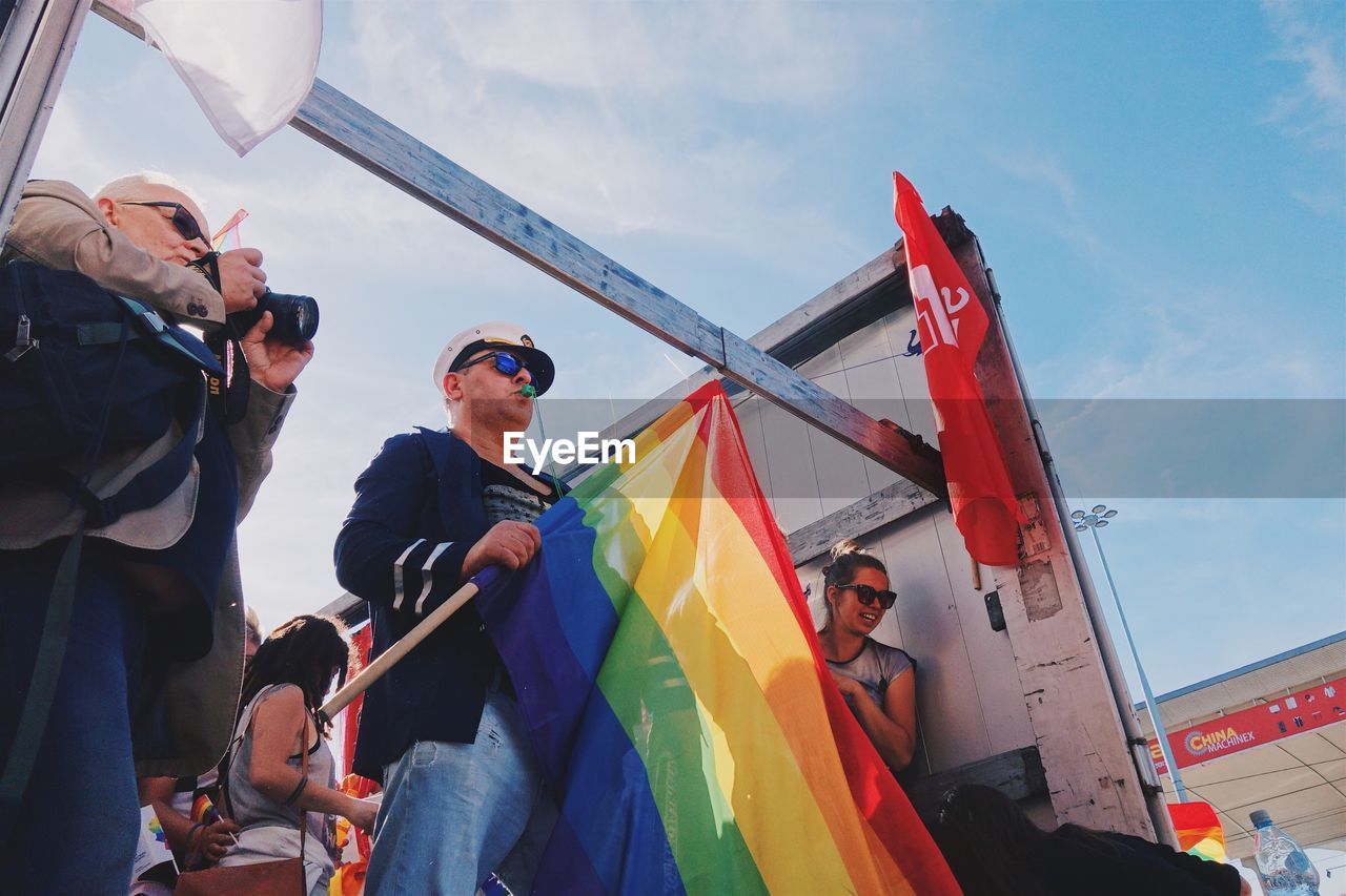 LOW ANGLE VIEW OF MEN ON BOAT