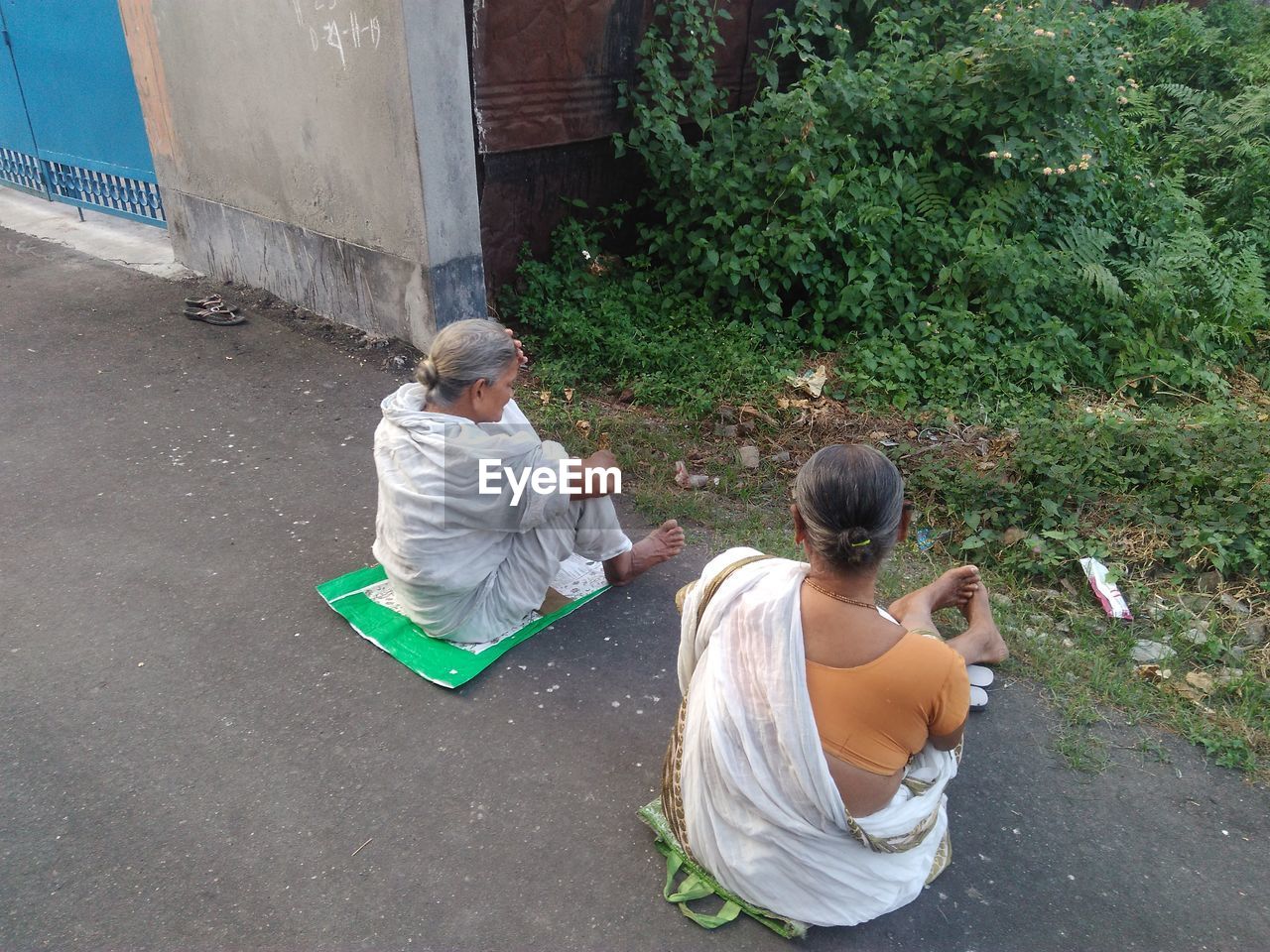 High angle view of women wearing saris sitting on road