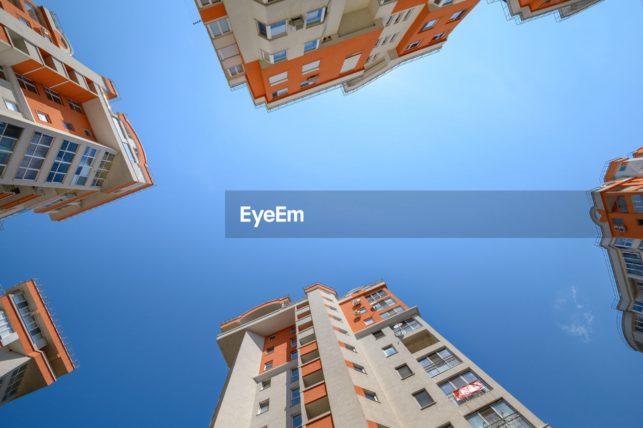 LOW ANGLE VIEW OF BUILDINGS IN TOWN AGAINST CLEAR SKY