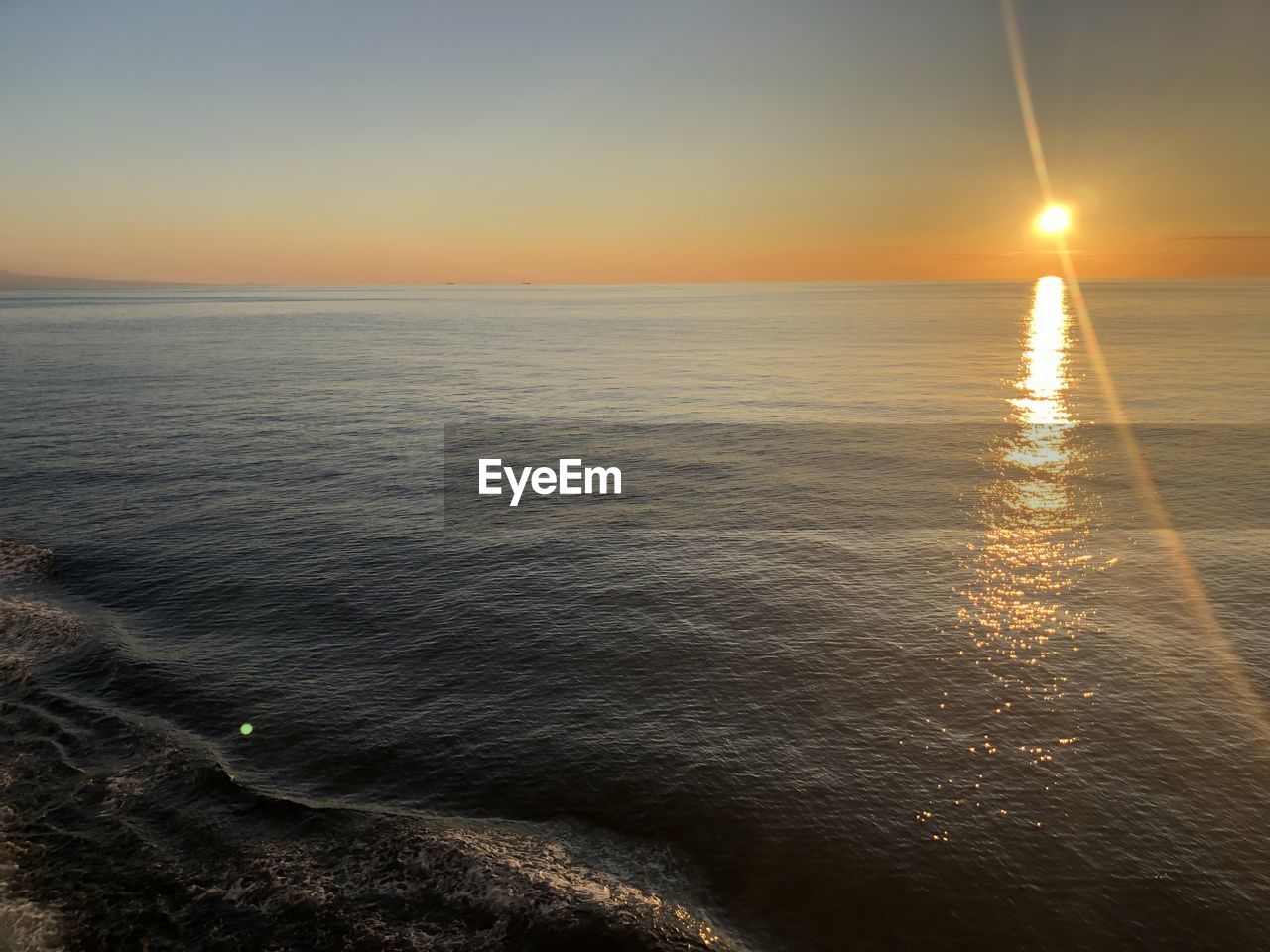 SCENIC VIEW OF SEA AGAINST ORANGE SKY