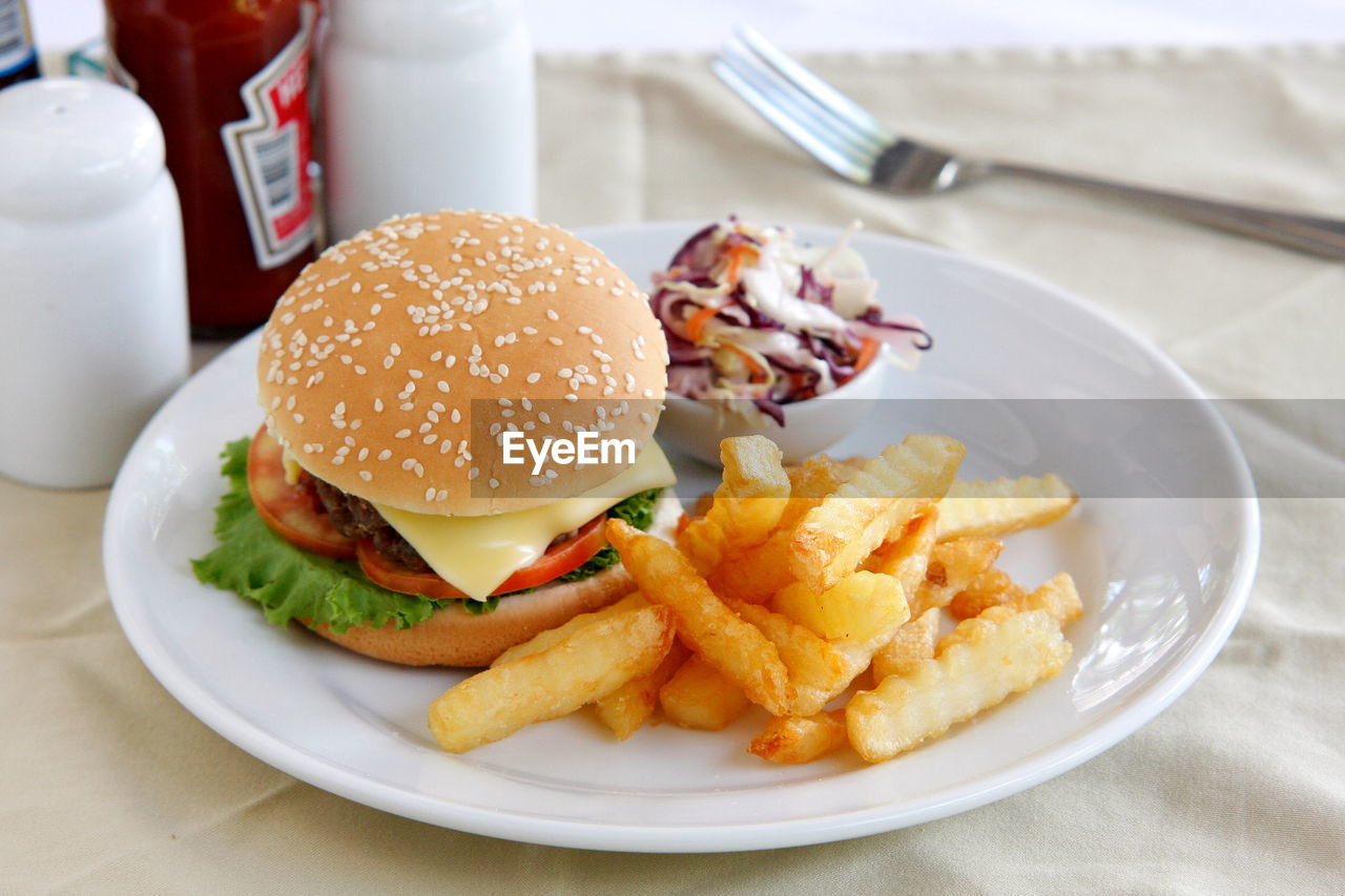 High angle view of hamburger and french fries in plate on table