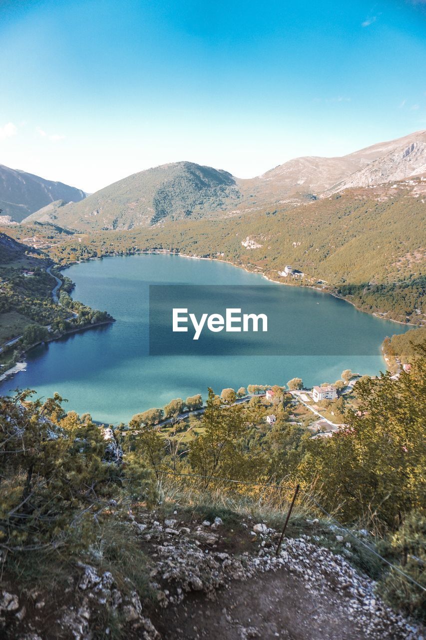 Scenic view of lake and mountains against sky