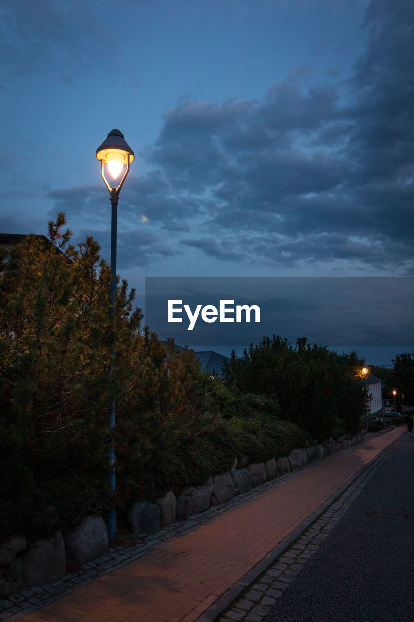 STREET LIGHT BY ROAD AGAINST SKY