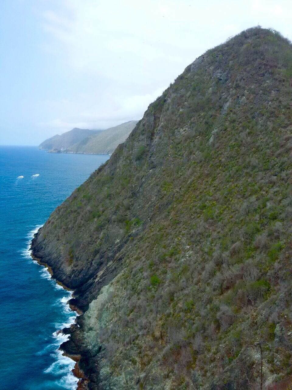 SCENIC VIEW OF SEA WITH MOUNTAINS IN BACKGROUND