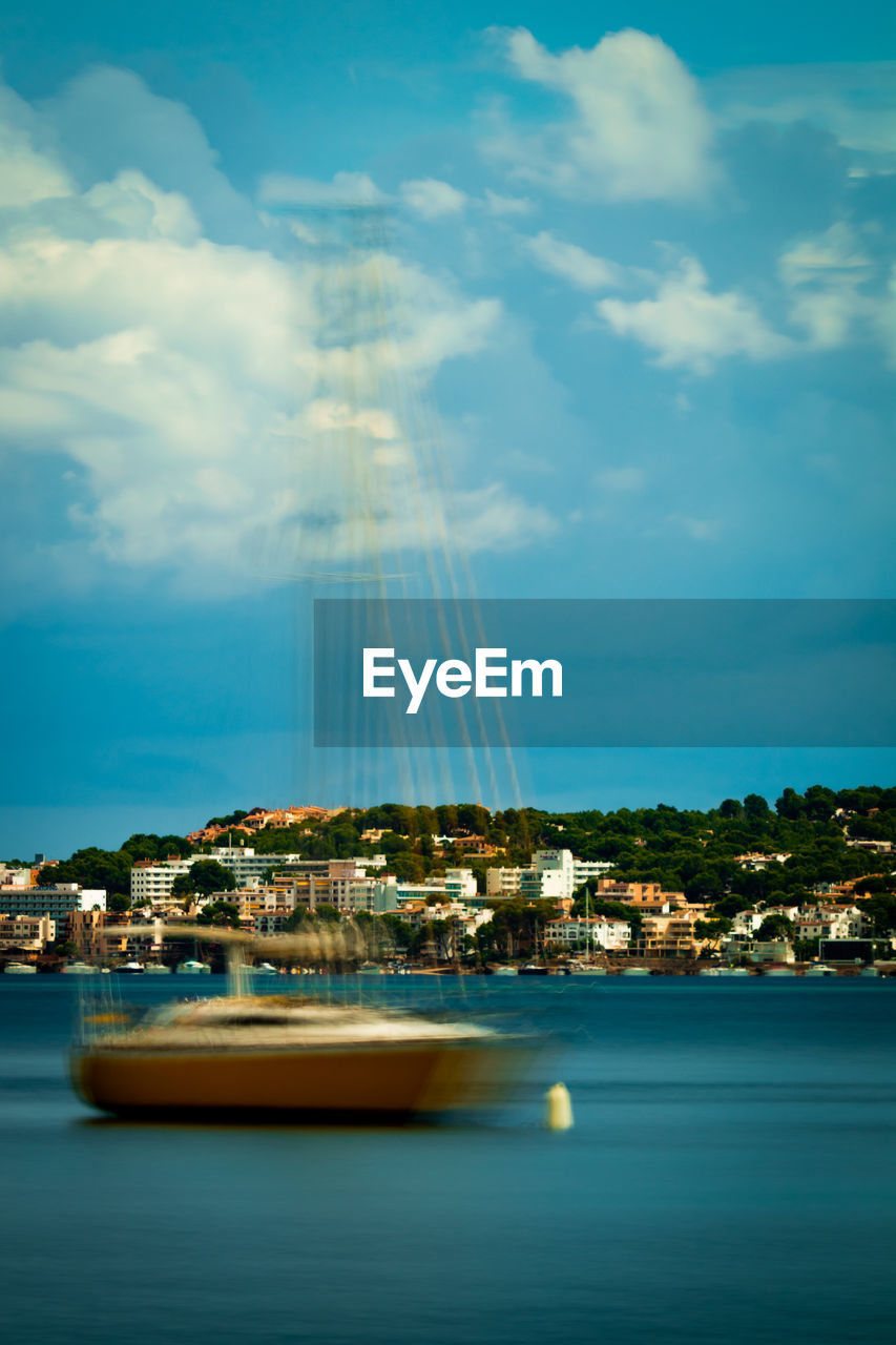 Scenic view of sea against sky in city