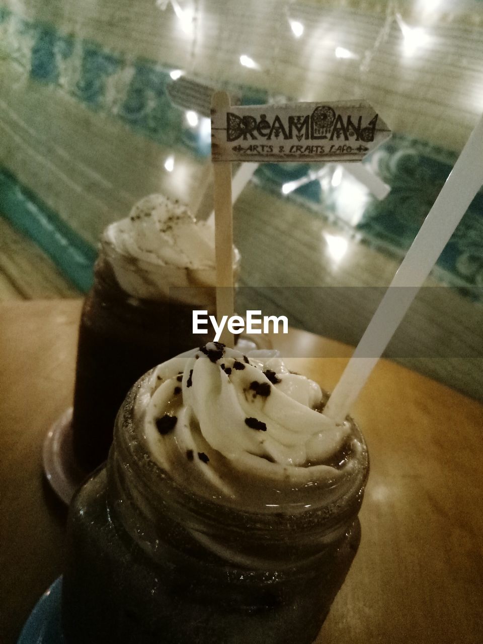 CLOSE-UP OF ICE CREAM IN GLASS ON TABLE