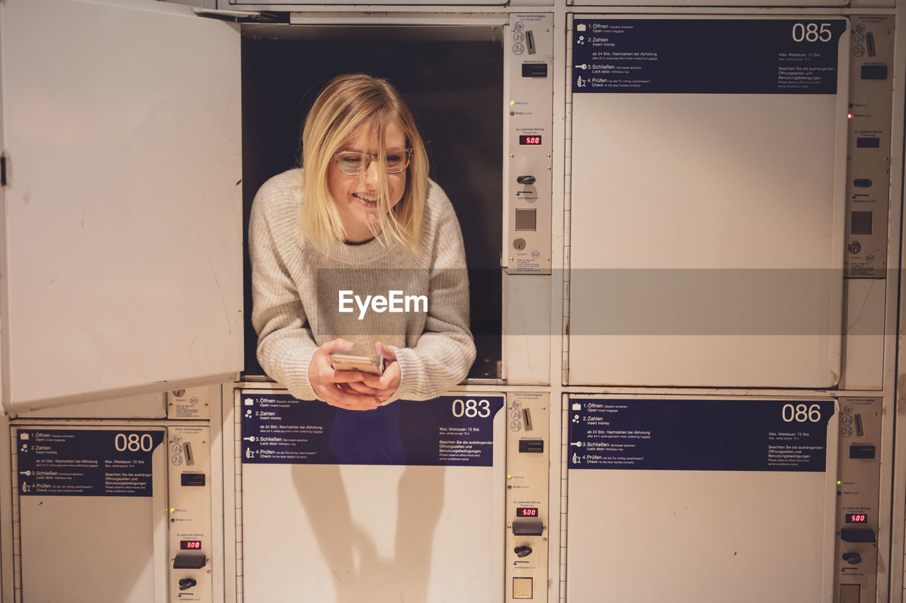 Young woman relaxing in locker