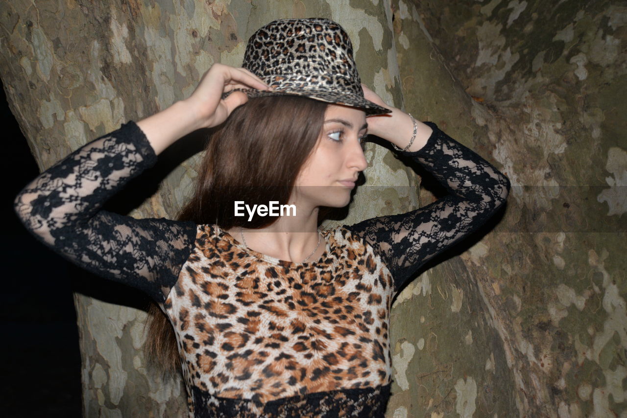 PORTRAIT OF A YOUNG WOMAN WITH HAT ON HAIR