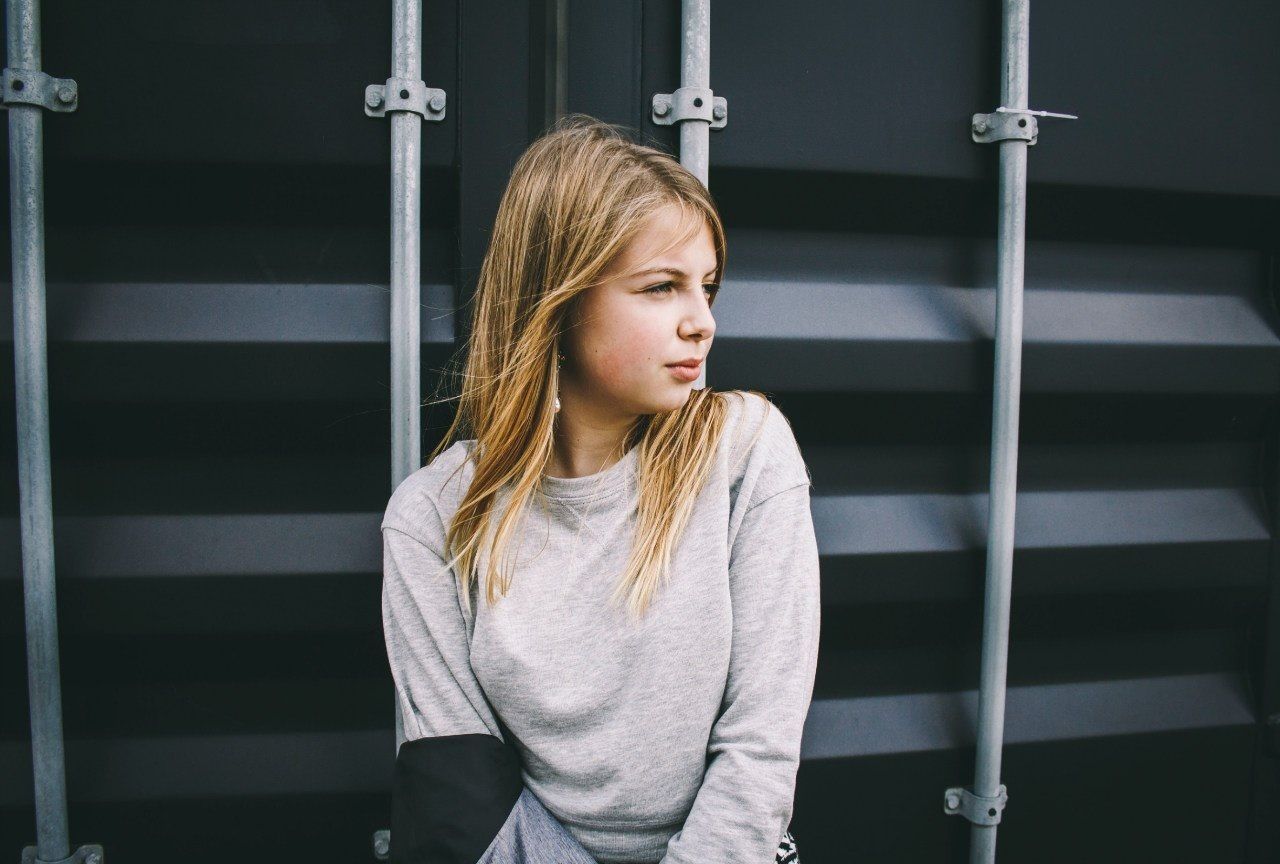 Beautiful serious young woman looking away