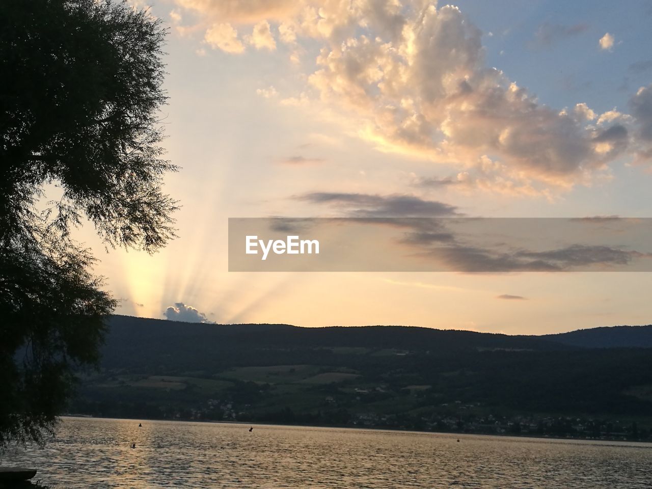 Scenic view of lake against cloudy sky