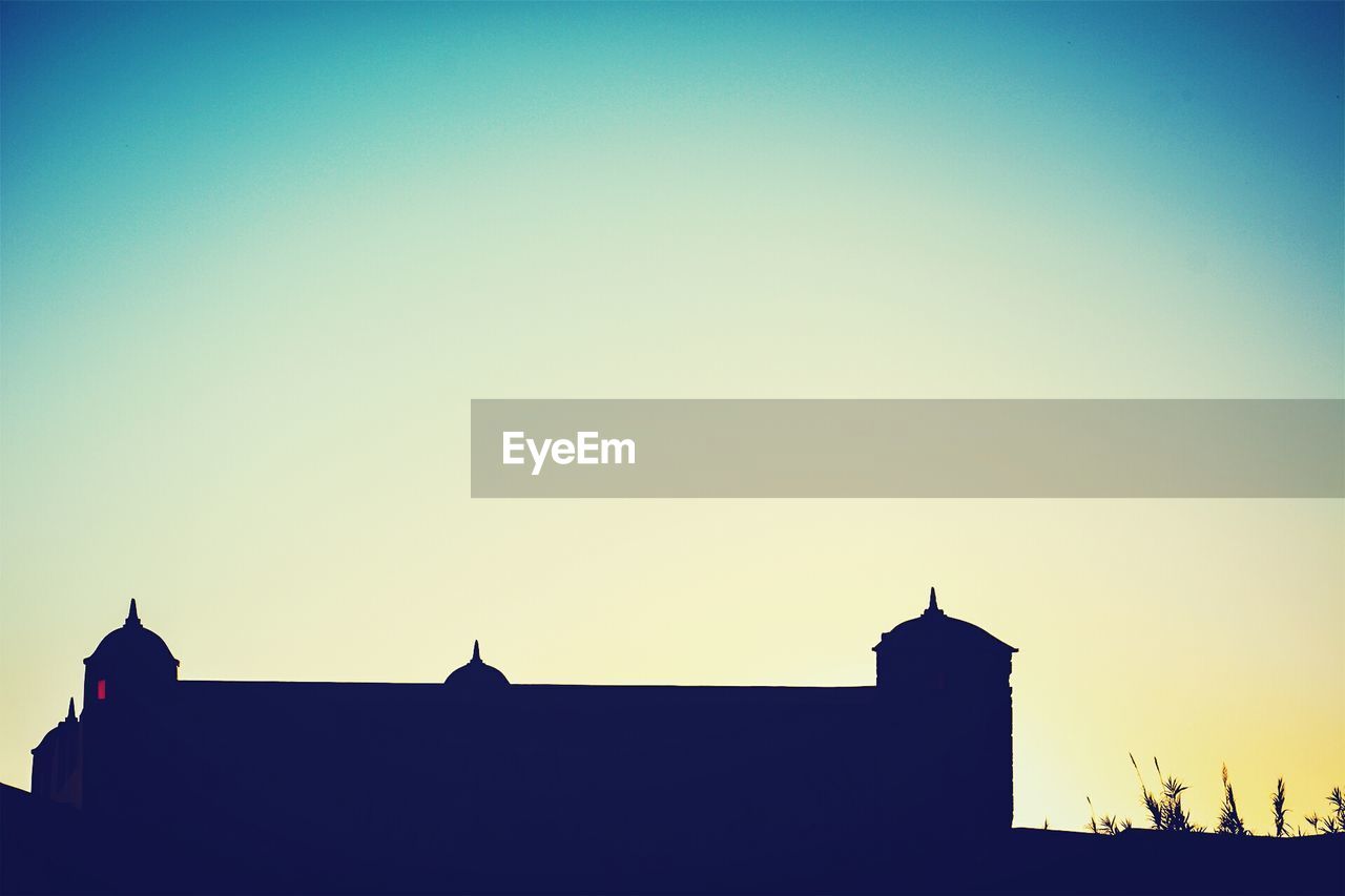 LOW ANGLE VIEW OF BUILDINGS AGAINST CLEAR SKY