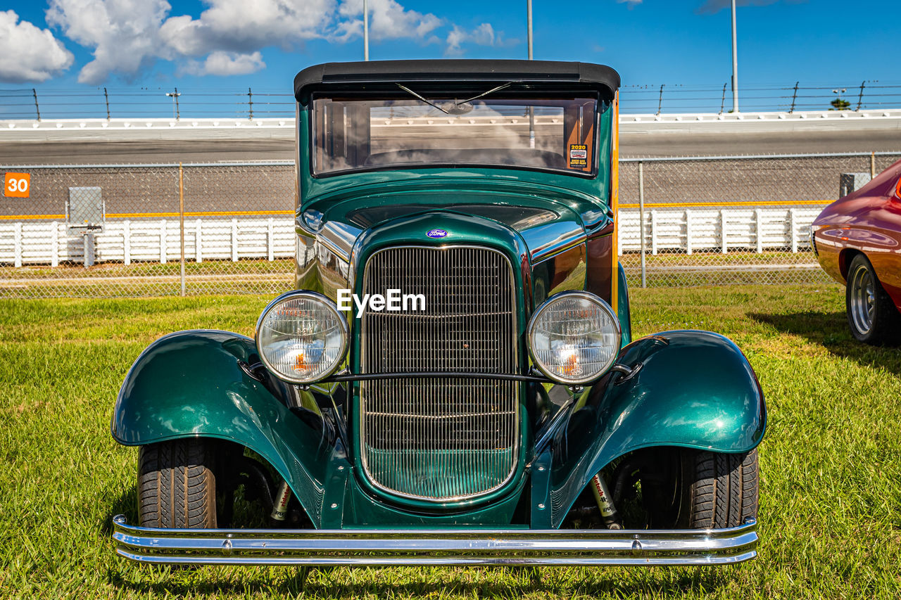 VIEW OF CAR ON FIELD