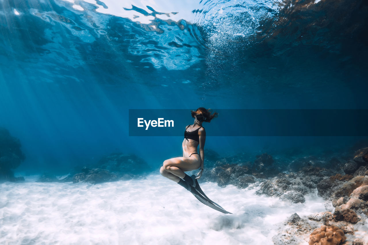 rear view of woman swimming in sea