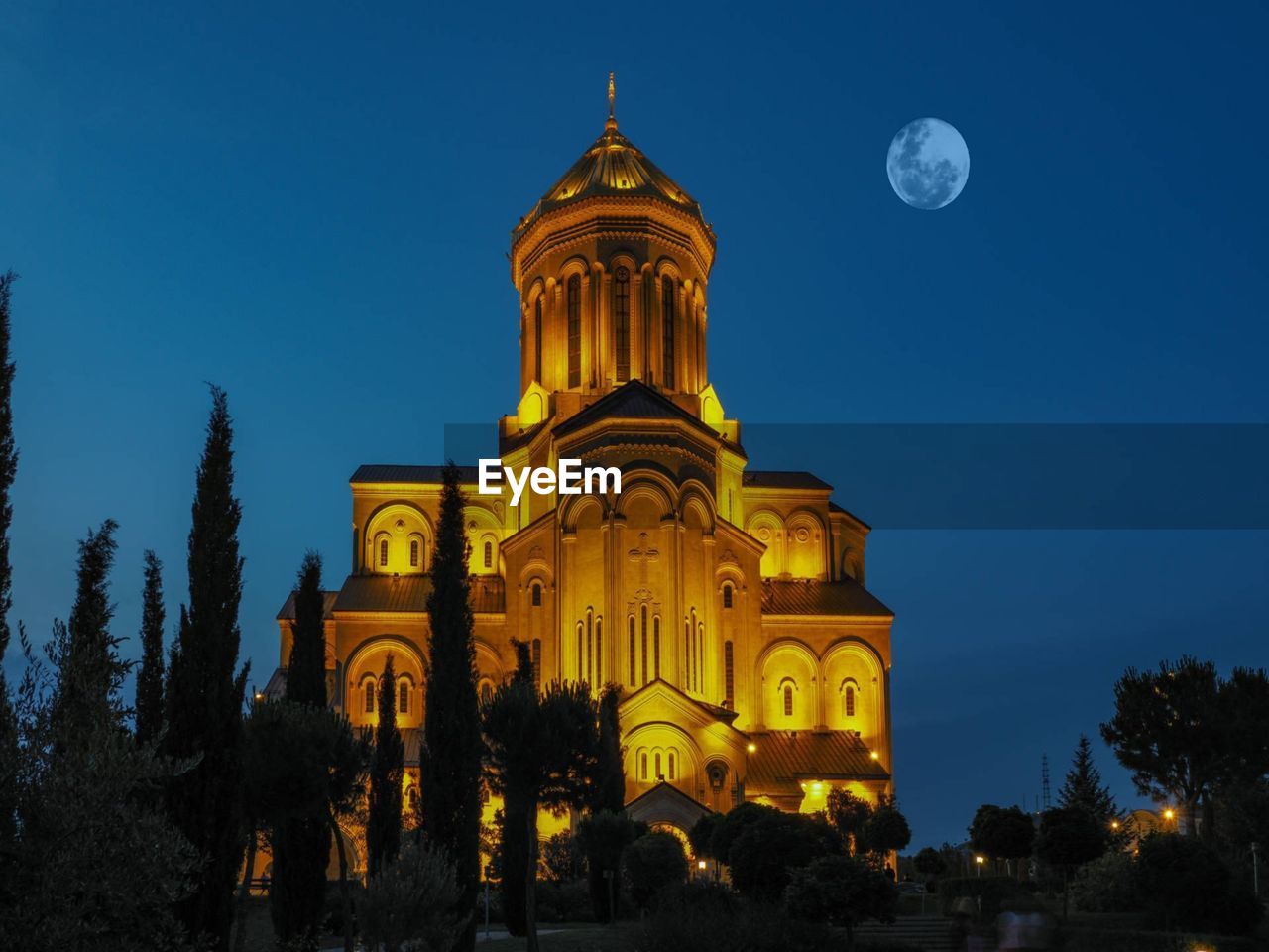 Low angle view of illuminated building against sky at night