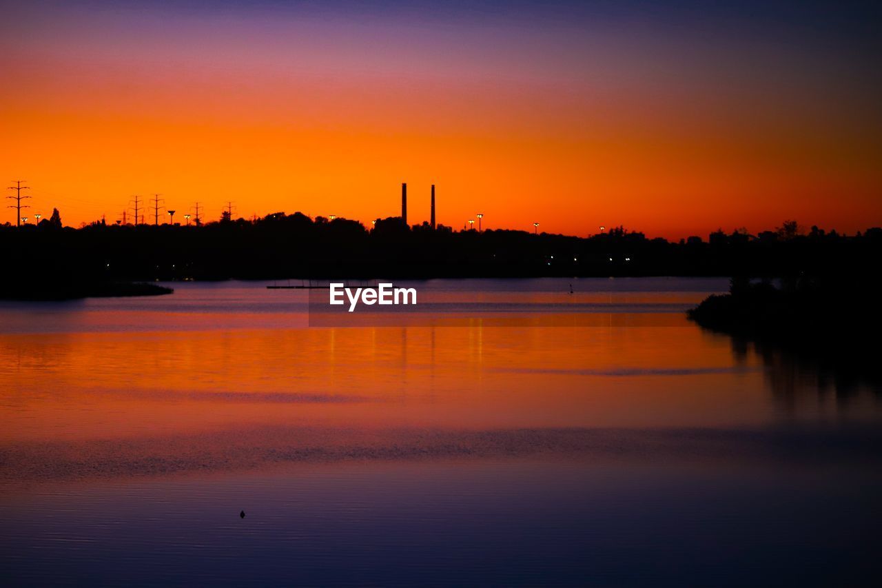 Scenic view of lake against romantic sky at sunset