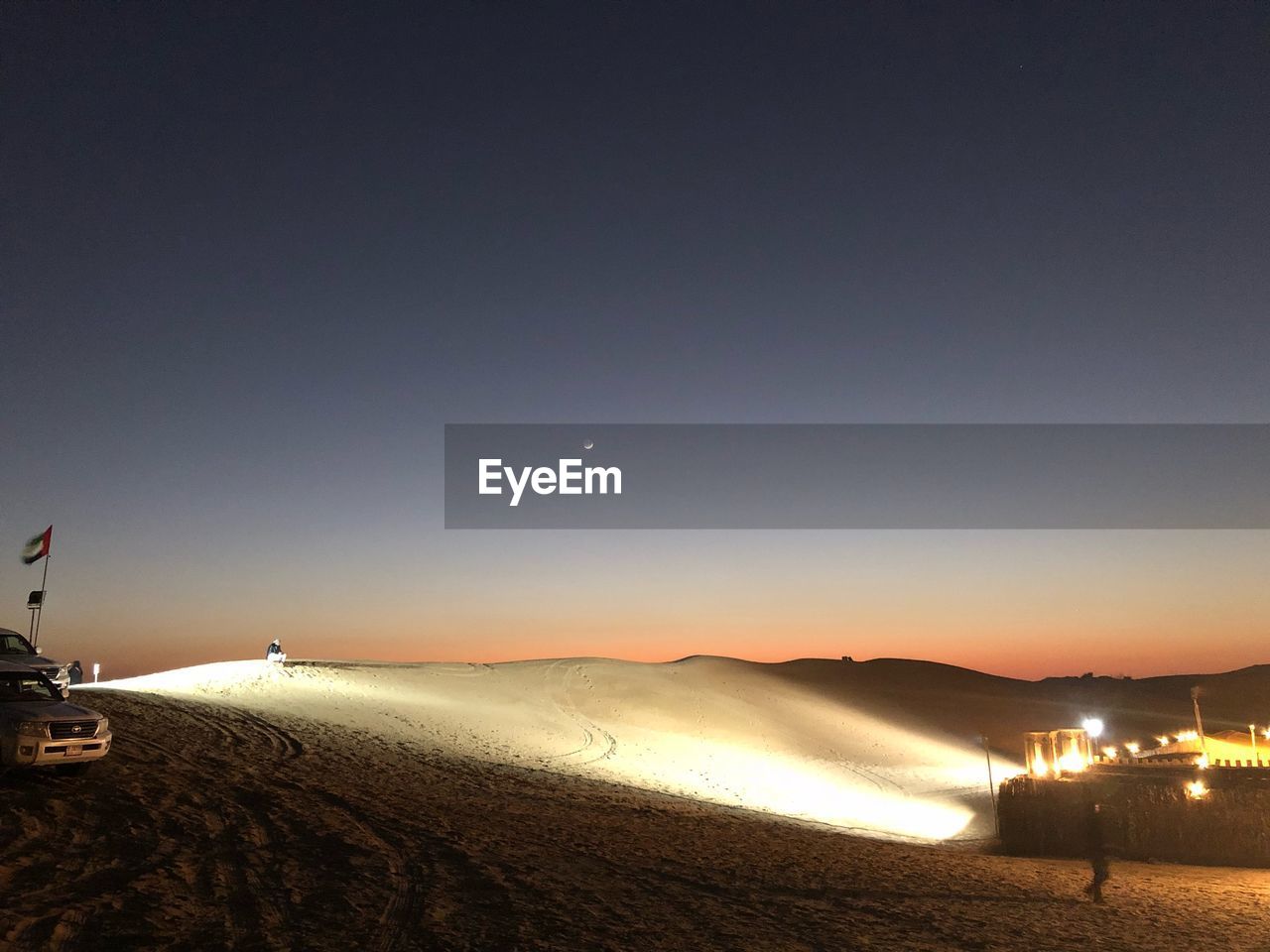 Scenic view of beach against clear sky at night