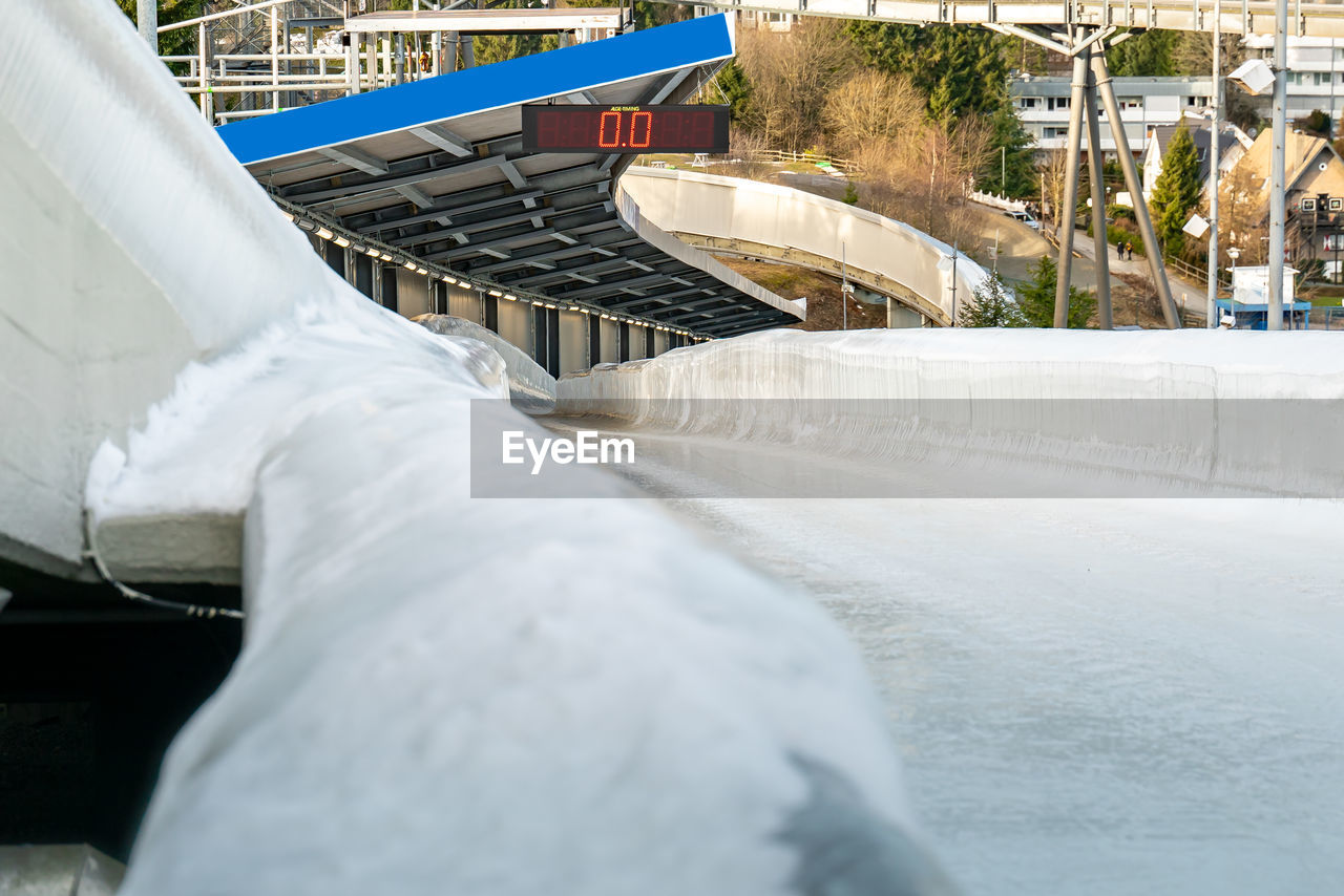 Bobsleigh ice channel in winterberg. the digital clock measures the speed. curvy trail in the ice.