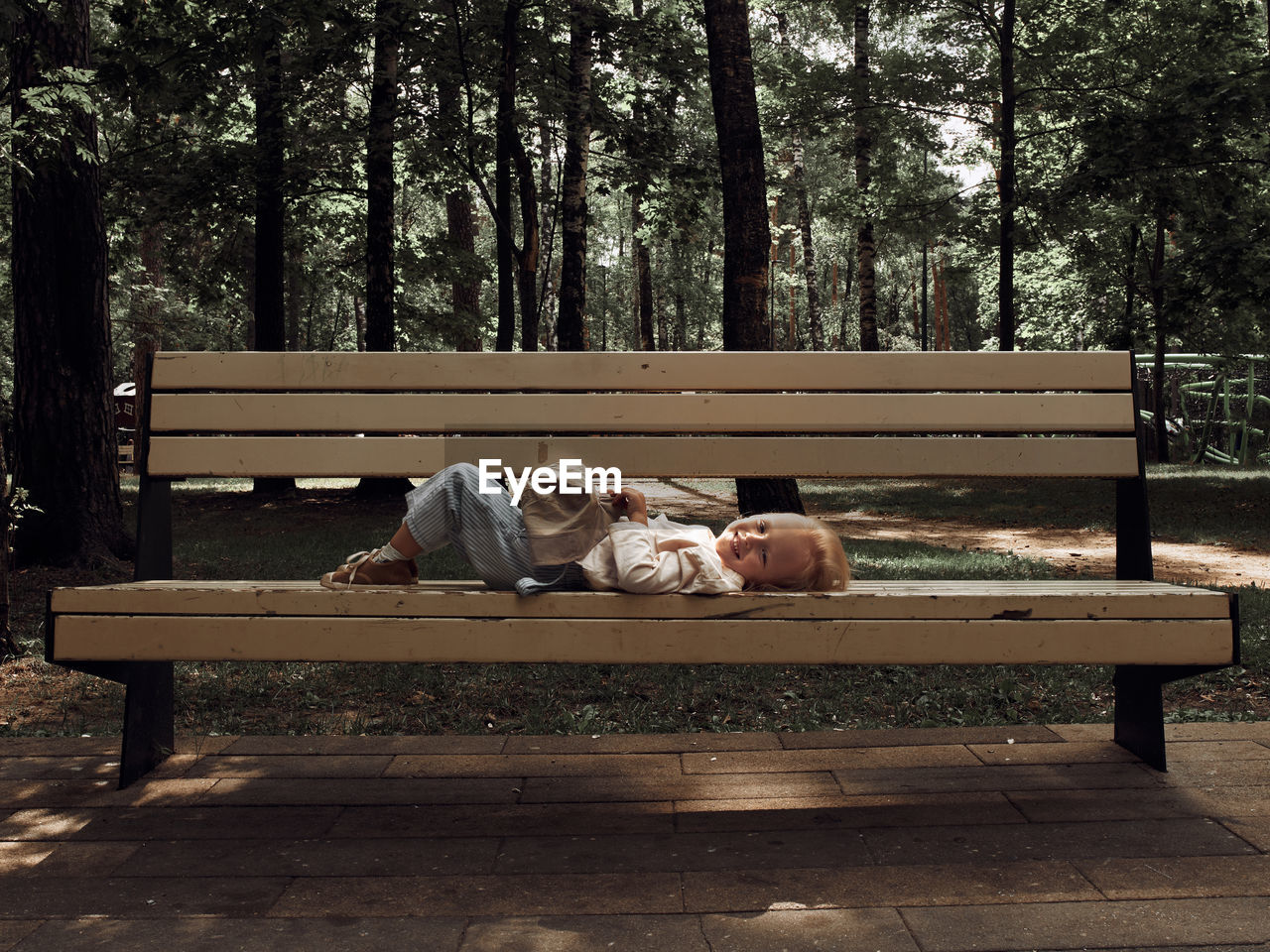 rear view of woman sitting on bench in park