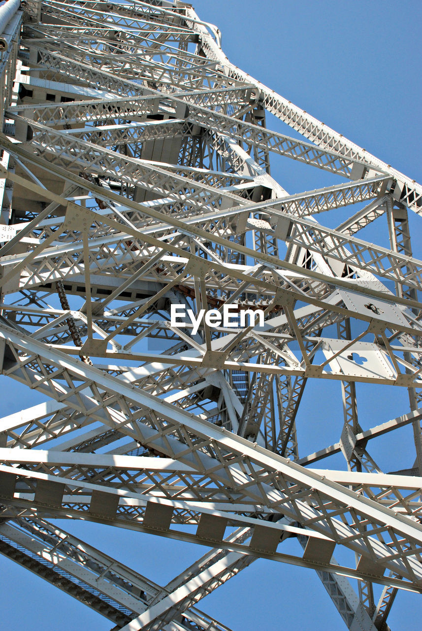 Low angle view of metallic structure against blue sky