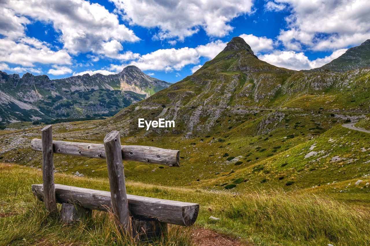 Scenic view of field and mountains against sky