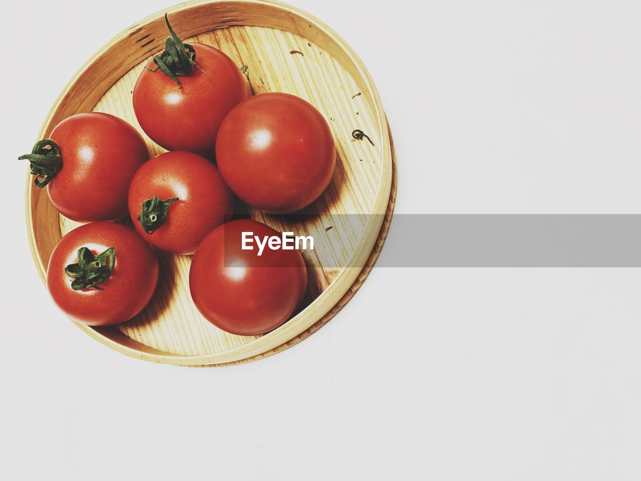 directly above shot of tomatoes in bowl on white background