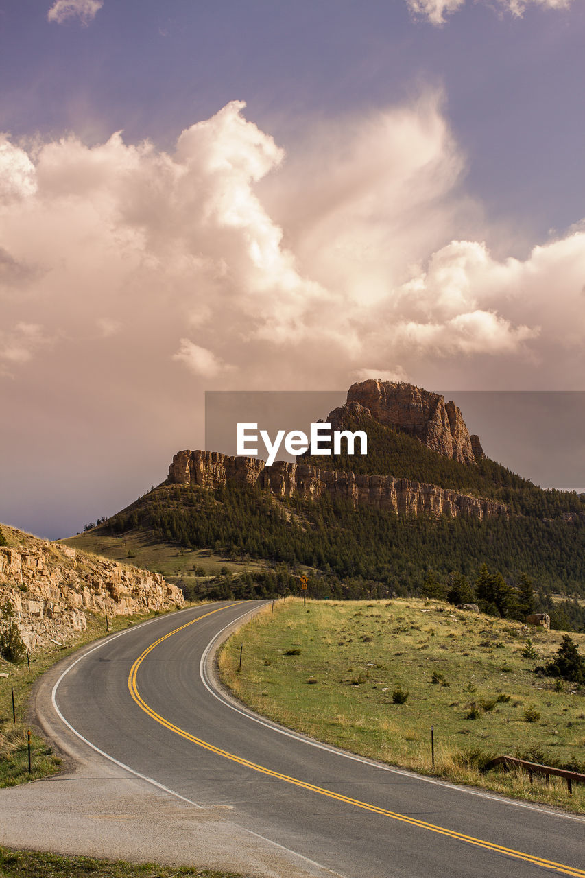 Road by mountain against sky