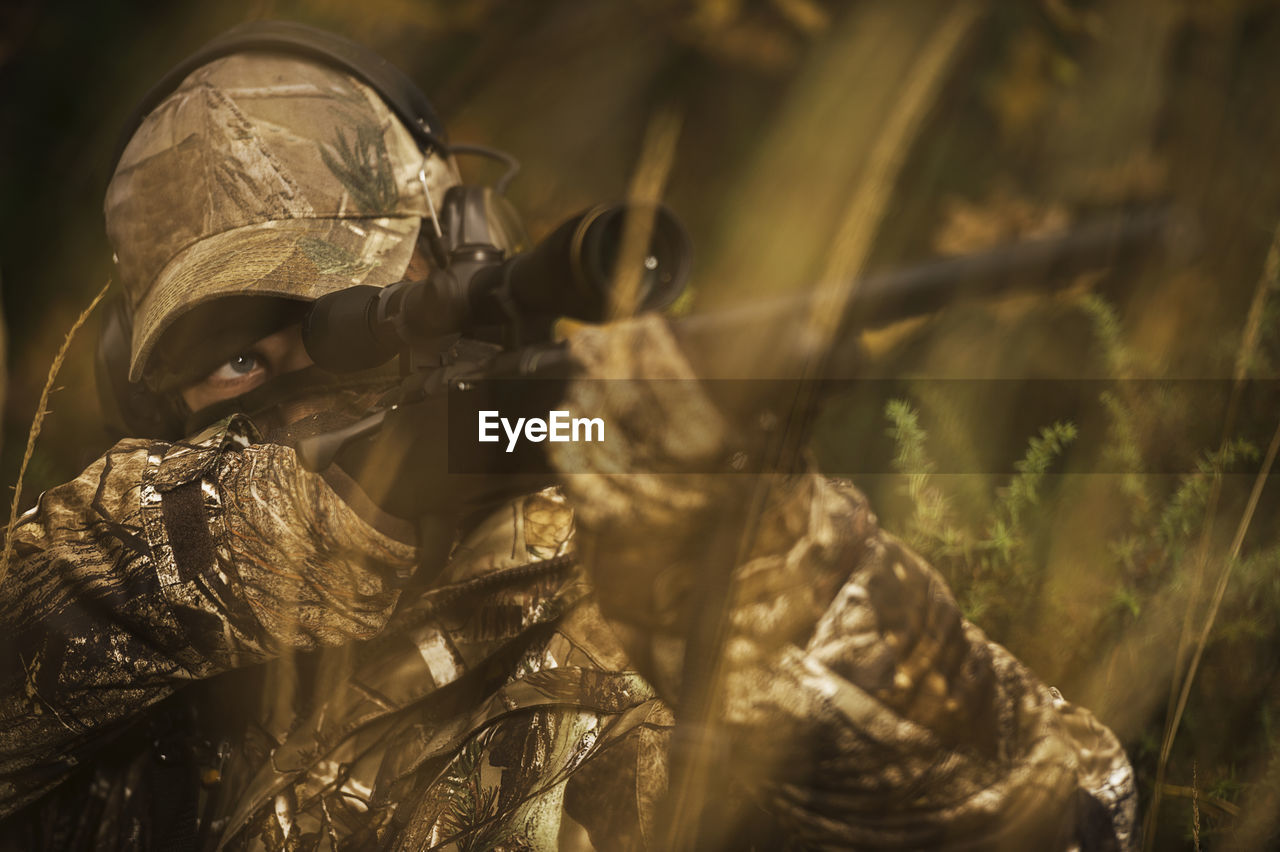 Teenage boy with rifle at hunting