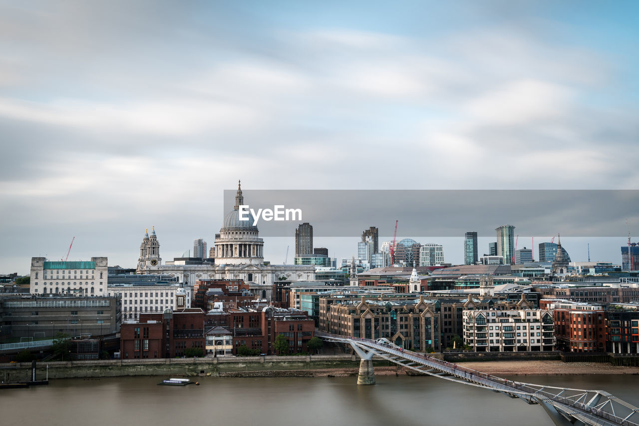 Dome of st. pauls cathedral and modern skyscrapers of london as seen from the river thames.