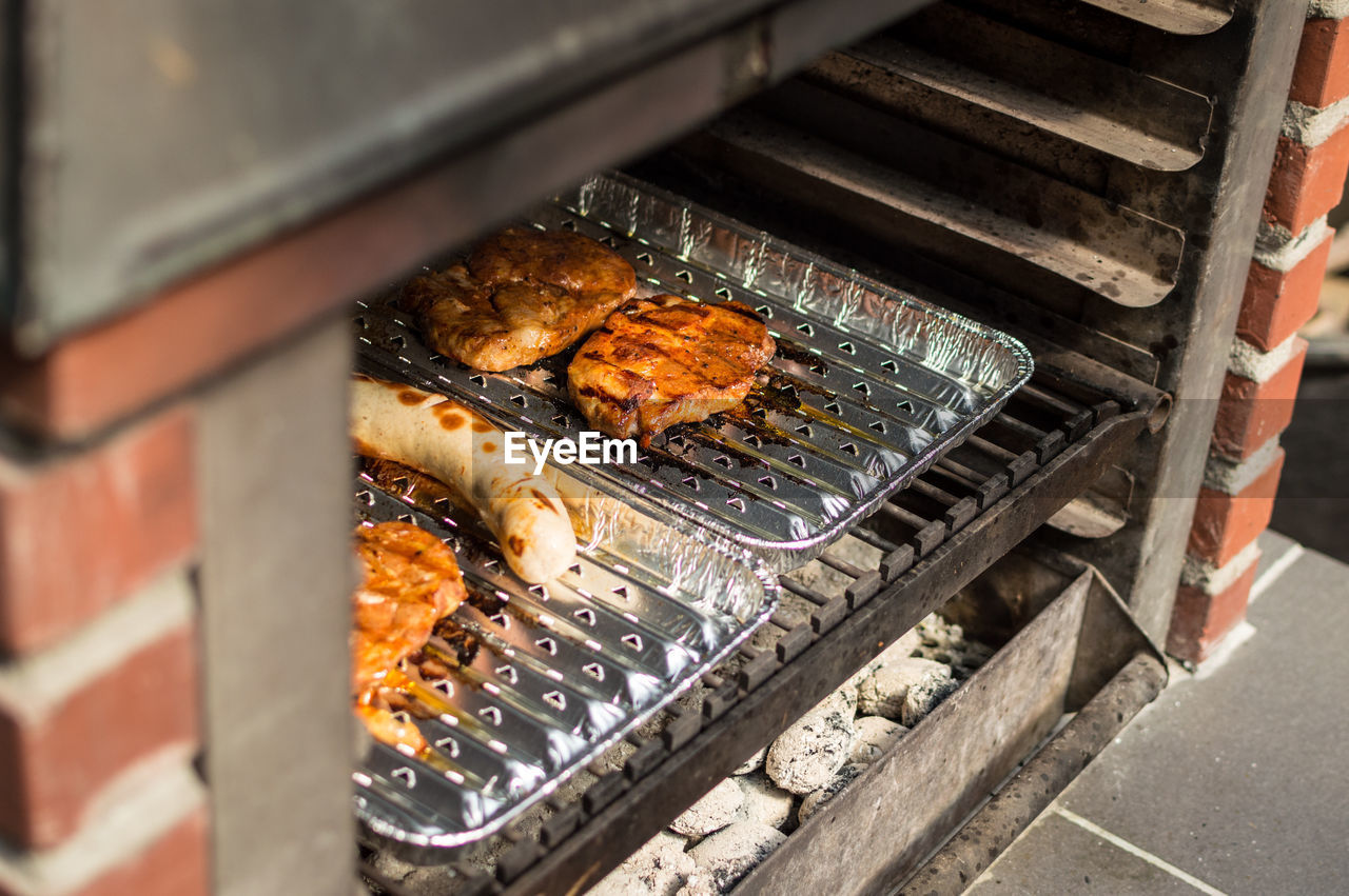 High angle view of meat cooking in oven