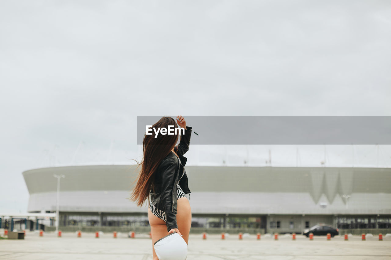 Rear view of woman walking on road