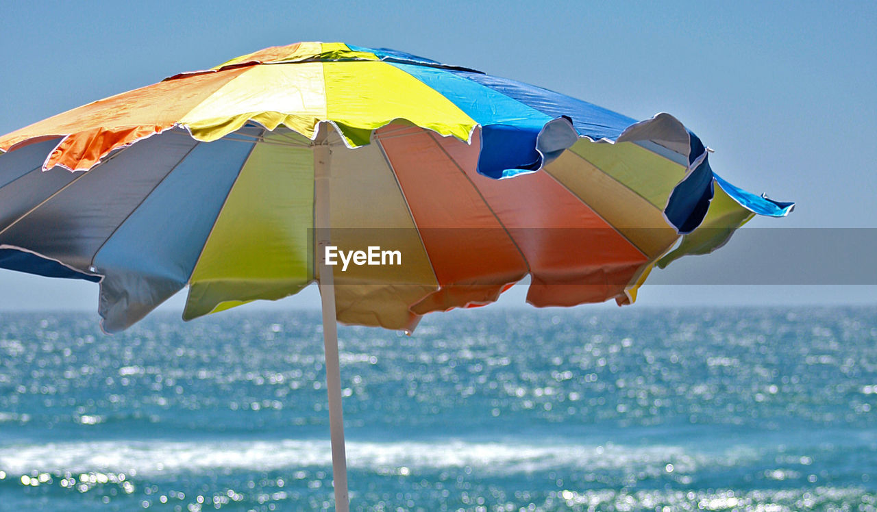 Colorful sunshade against sea