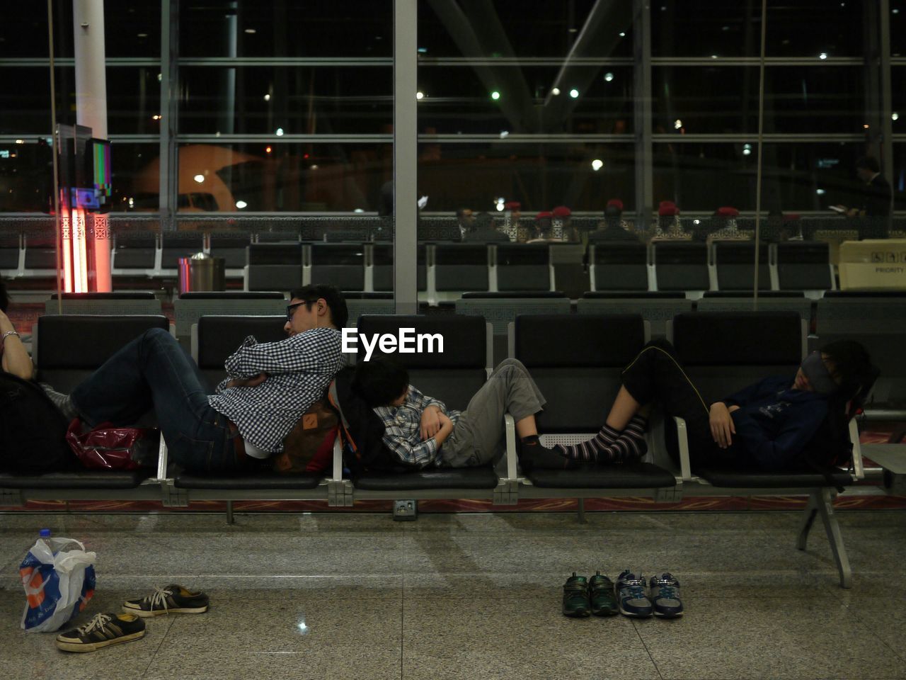 CLOSE-UP OF PEOPLE SITTING ON WALL