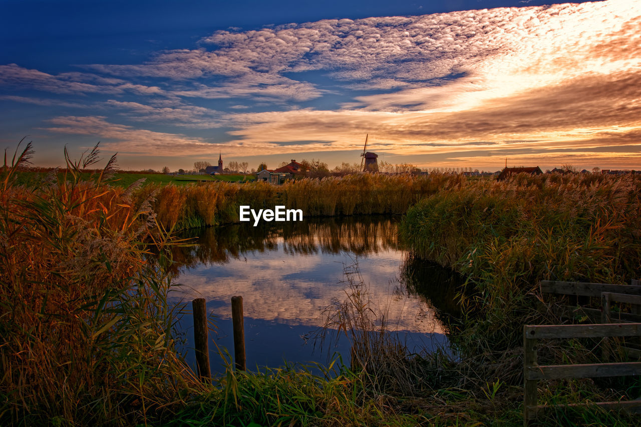 Scenic view of field against sky during sunset