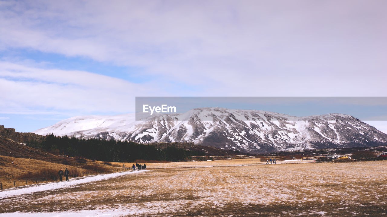 Scenic view of landscape and snowcapped mountains during winter