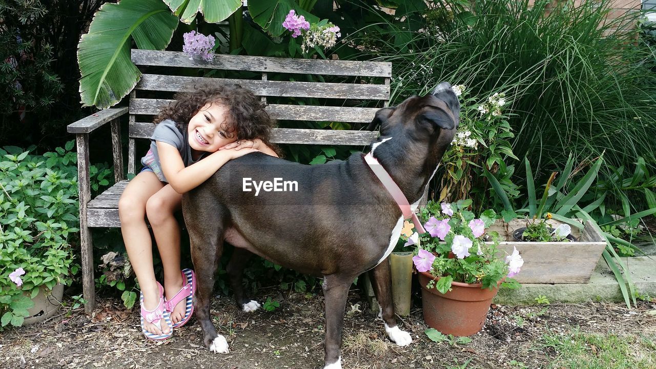Cute girl with dog in back yard