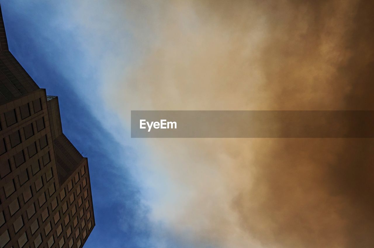 Low angle view of building against sky during sand fire
