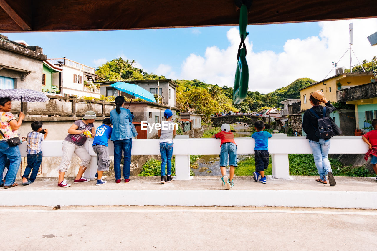 GROUP OF PEOPLE AGAINST BUILDING