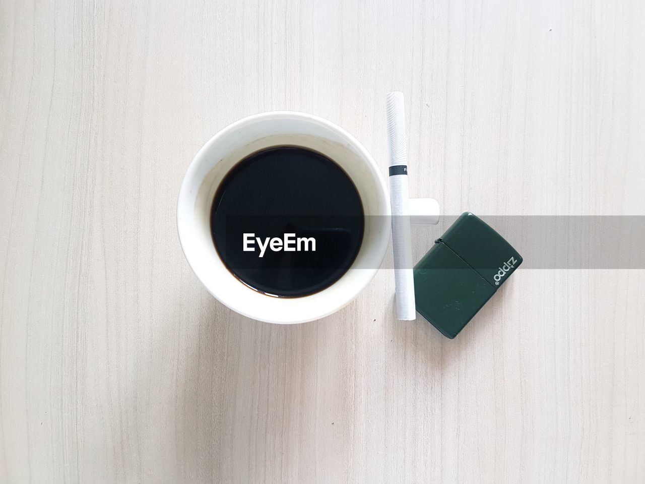 CLOSE-UP OF COFFEE CUP ON TABLE WITH SPOON