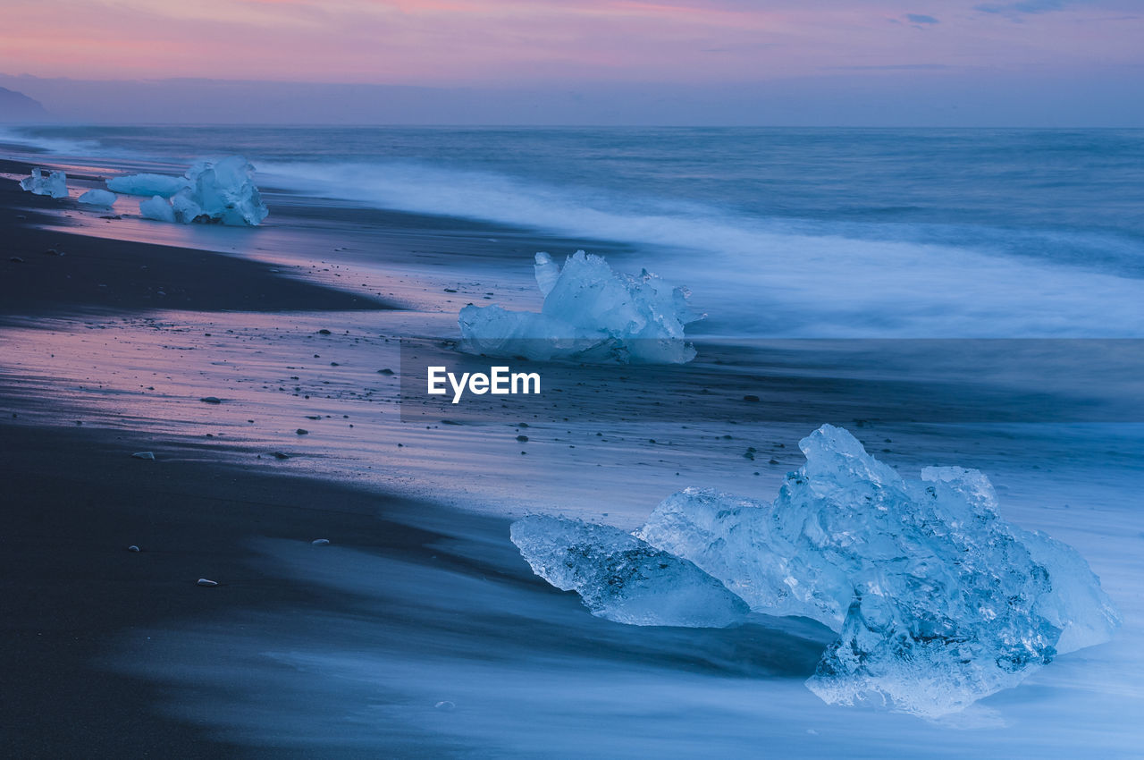 Ice lying on black volcanic beach. iceland