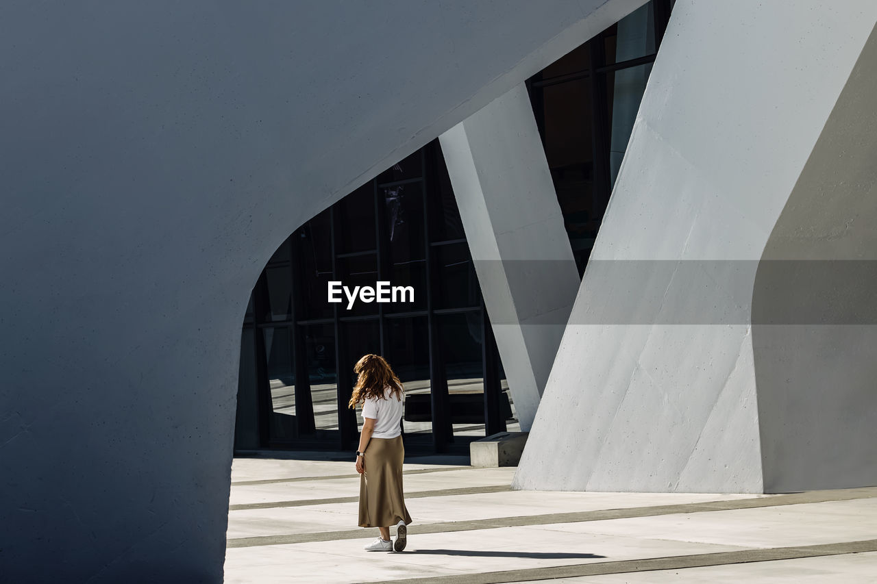 Portrait of woman standing in geometric modern architecture urban space