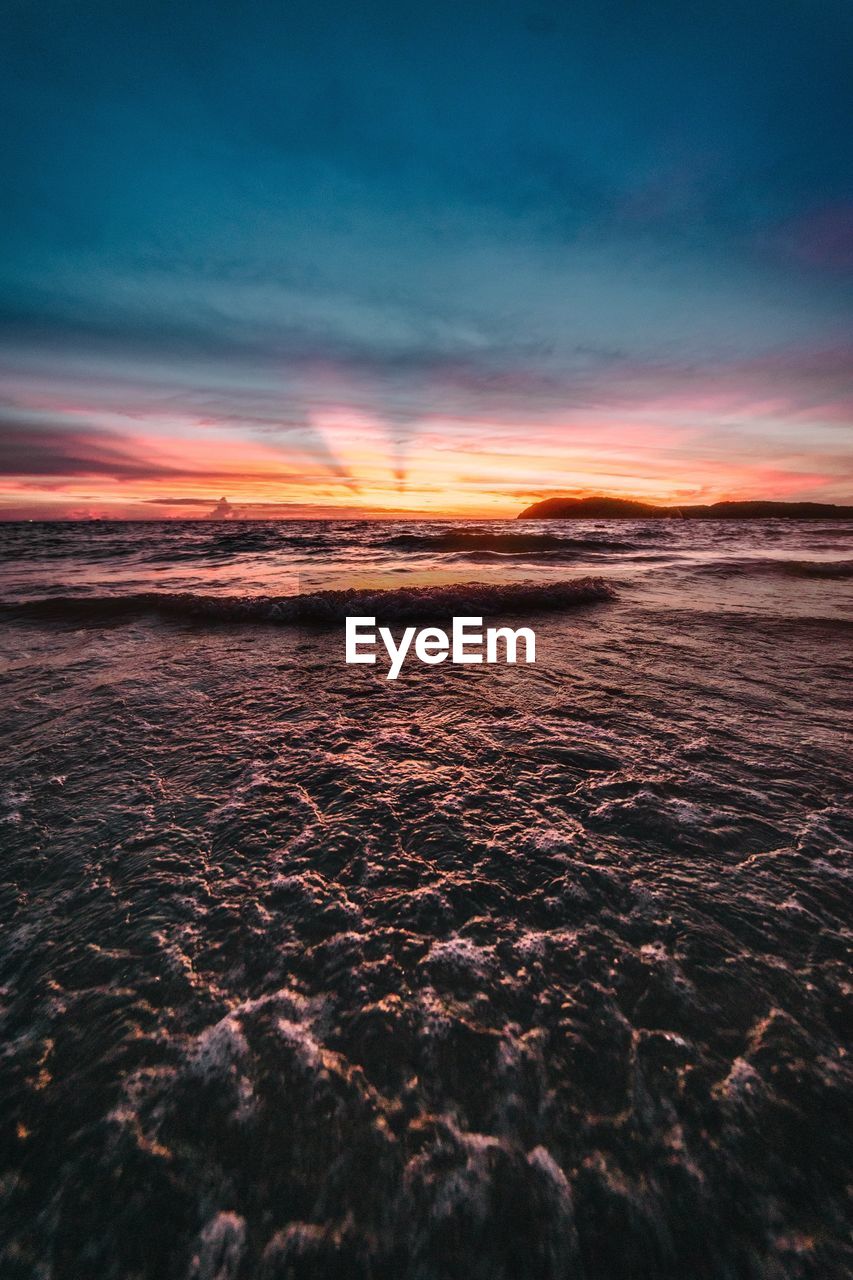 Scenic view of beach against sky during sunset